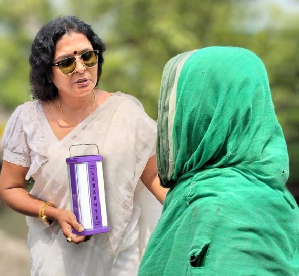 A woman with a scrunched smile gives a side hug to her mother.